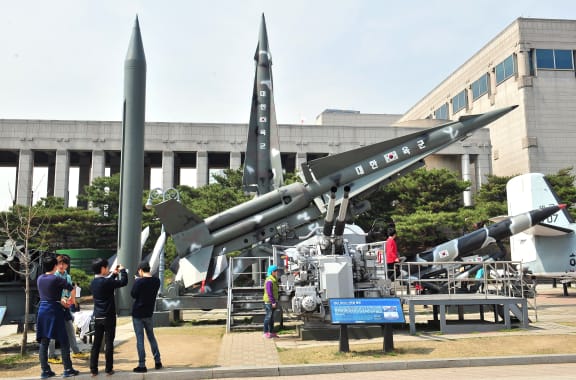 Visitors look at replicas of North Korean missiles at the Korean War Memorial in Seoul after North Korea test-fired two medium-range ballistic missiles.