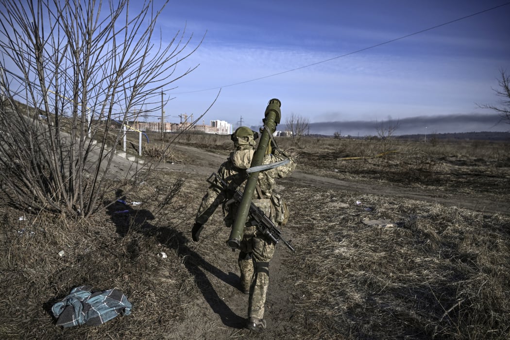 A Ukranian serviceman walks towards the front line in the city of Irpin, northern Ukraine, on 12 March 2022.
