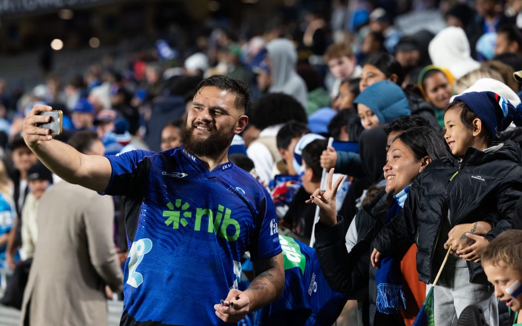 Blues prop Angus Ta'avao with fans.