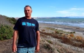 Craig Marfell has built several log barricades to keep motorists from damaging areas above the high tide line