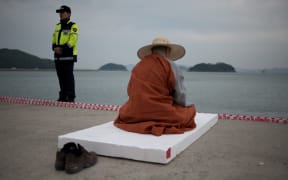 A monk offers prayers for victims of the Sewol ferry.