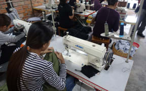 A machinist in a Cambodian factory.
