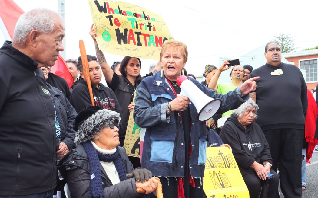 Dame Naida Glavish (with loud hailer) speaks out against Kaipara District Council removing karakia from the start of its council meetings in a 2022 protest march in Dargaville.