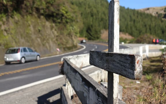 A cross stands on State Highway 5, marking the spot of a fatal crash on the road