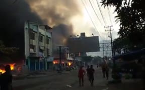 Buildings near the port being torched in Jayapura