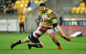 Hurricanes wing Ben Lam makes a break against the Lions.