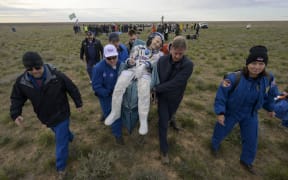 This hanodut picture courtesy of NASA shows NASA astronaut Don Pettit (C)  being carried to a medical tent shortly after he, and Roscosmos cosmonauts Alexey Ovchinin and Ivan Vagner landed in their Soyuz MS-26 spacecraft near the town of Zhezkazgan, Kazakhstan on April 20, 2025. The trio are returning to Earth after logging 220 days in space as a members of Expeditions 71 and 72 aboard the International Space Station. (Photo by Bill INGALLS / NASA / AFP) / RESTRICTED TO EDITORIAL USE - MANDATORY CREDIT "AFP PHOTO / NASA/BILL INGALLS" - NO MARKETING - NO ADVERTISING CAMPAIGNS - DISTRIBUTED AS A SERVICE TO CLIENTS