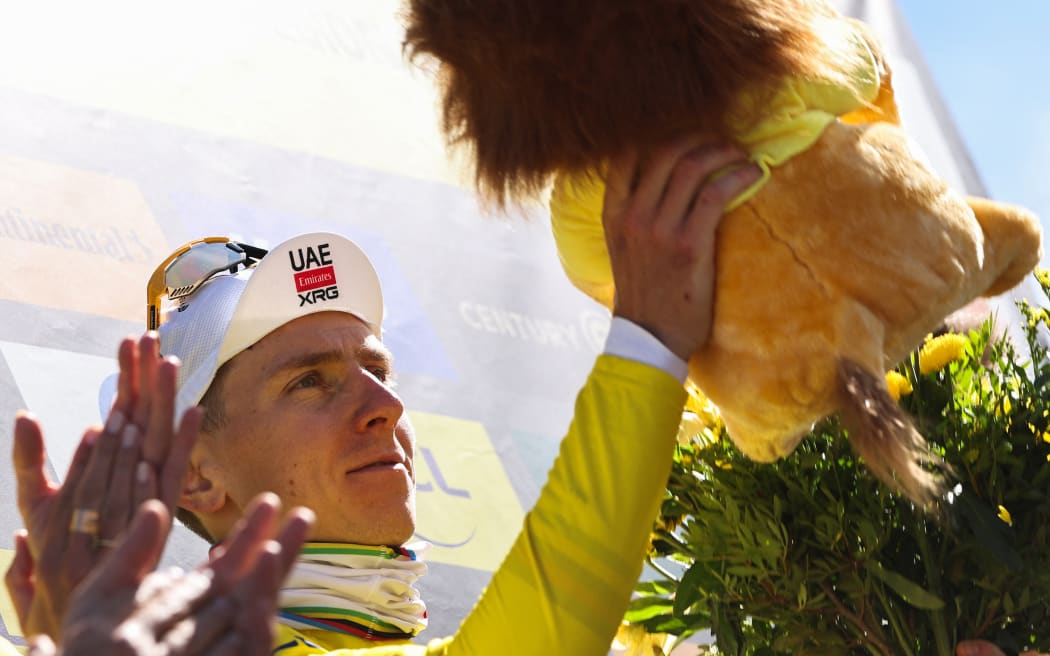 Slovenian rider Tadej Pogacar celebrates on the podium with the overall leader's yellow jersey after the 16th stage of the Tour de France, 171.5 km between Montpellier and Mont Ventoux, southern France, on July 22, 2025. (Photo by Anne-Christine POUJOULAT / AFP)