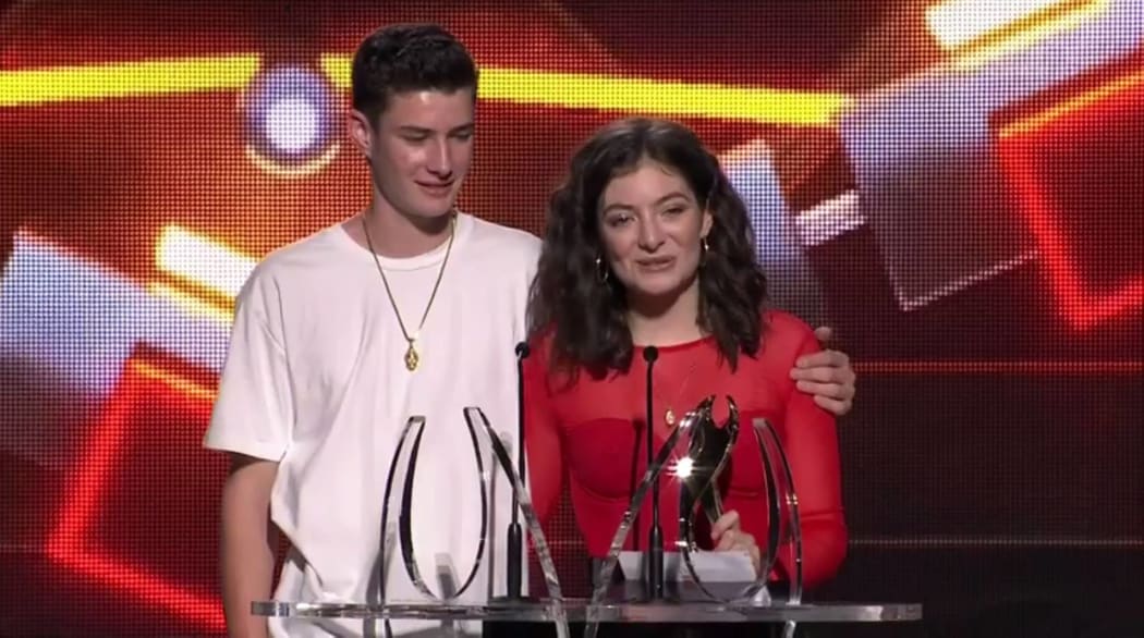 Lorde accepts her final award of the night with her brother.
