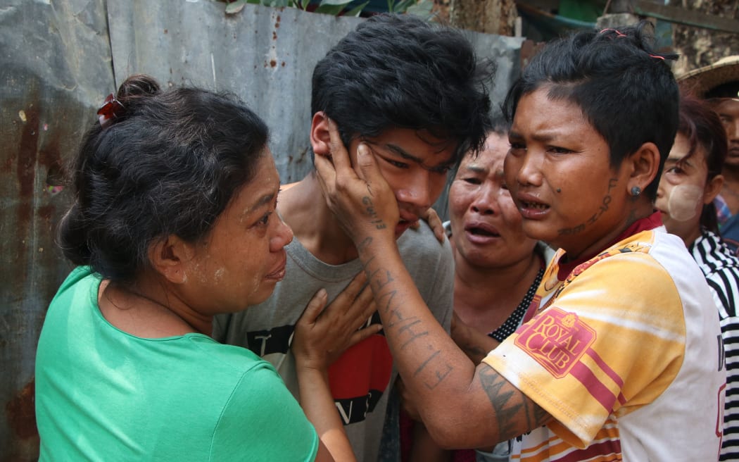 YANGON, MYANMAR - MARCH 27: Relatives mourn at the funeral of a person, who was killed during a demonstration against the military coup in Yangon, Myanmar on March 27, 2021.
