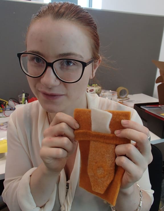 Charlotte holding a pocket with a flap
