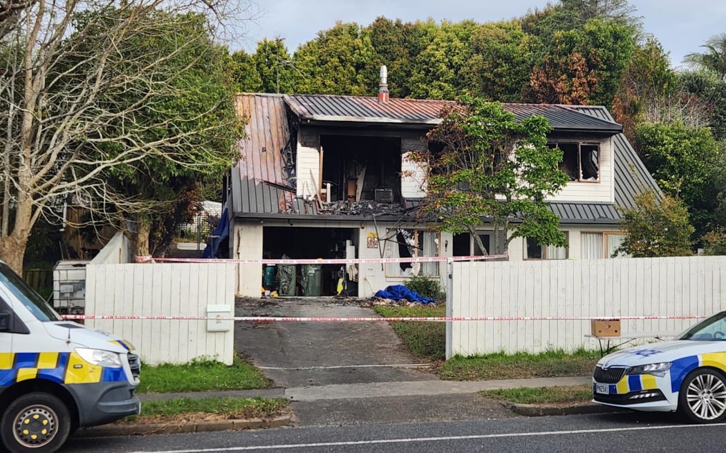 Police guard at the scene of the Bucklands beach double homicide fire.