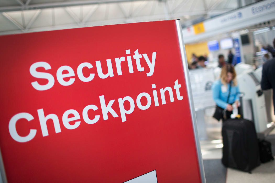 A sign directs travellers to a security checkpoint staffed by Transportation Security Administration (TSA) workers at O'Hare Airport in Chicago, Illinois in June 2015.
