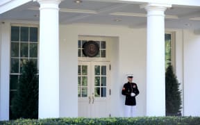 WASHINGTON, DC - OCTOBER 07: A U.S. Marine stands watch outside the doors of the White House West Wing October 07, 2020 in Washington, DC. According to the White House, President Donald Trump was in the Oval Office Wednesday afternoon, three days after returning from Walter Reed National Military Medical Center after tested positive and being treated for COVID-19.   Chip Somodevilla/Getty Images/AFP (Photo by CHIP SOMODEVILLA / GETTY IMAGES NORTH AMERICA / Getty Images via AFP)