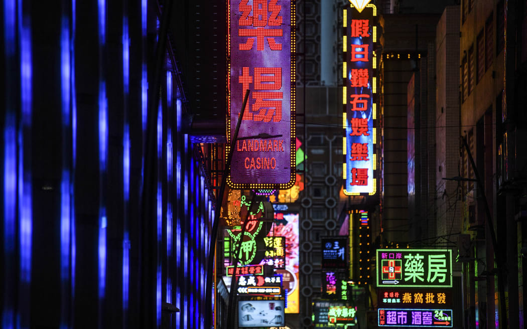 Neon signage for the Landmark Casino (C) is seen in Macau on January 22, 2020, after the former Portuguese colony reported its first case of the new SARS-like virus that originated from Wuhan in China. - Macau on January 22 reported its first confirmed case of the new SARS-like coronavirus as authorities announced all staff in the city's bustling casinos had been ordered to wear face masks. (Photo by Anthony WALLACE / AFP)