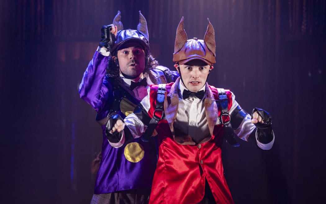 Two actors in horse costumes simulate a race.