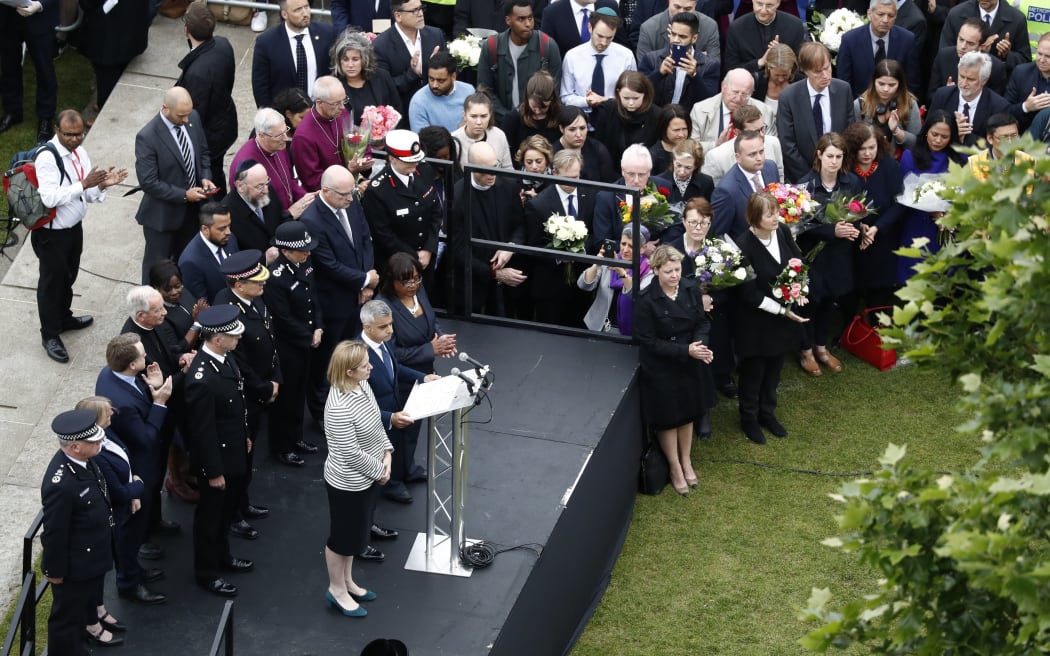 People gather at Potters Fields Park as London Mayor Sadiq Khan speaks flanked by Home Secretary Amber Rudd and Shadow Home Secretary Diane Abbott on the podium, in London on June 5, 2017 during a vigil to commemorate the victims of the terror attack on London Bridge and at Borough Market.