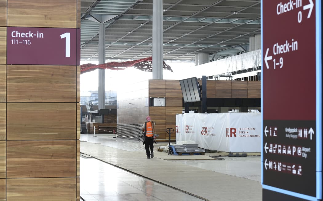 A construction worker in the uncompleted Berlin Brandenburg airport, which was originally expected to open five years ago.