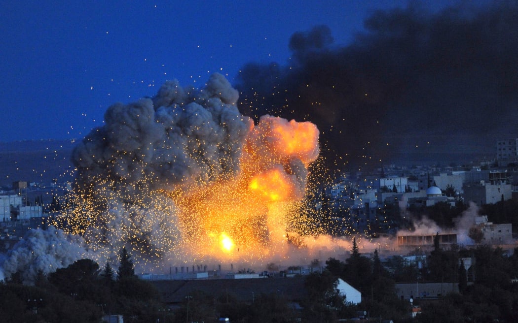Smoke and flames rise following an explosion in the Syrian town of Kobane, seen from southeastern Turkey.