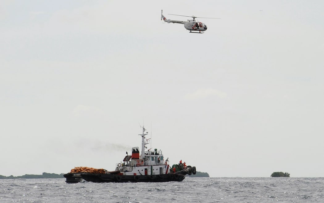 A helicopter hovers above the site where  a ferry collided with a ship near the central Philippine city of Cebu in August 2013.