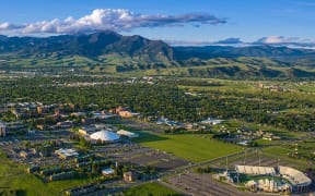 A photograph of the Bozeman, Montana with a mountain range in the background.