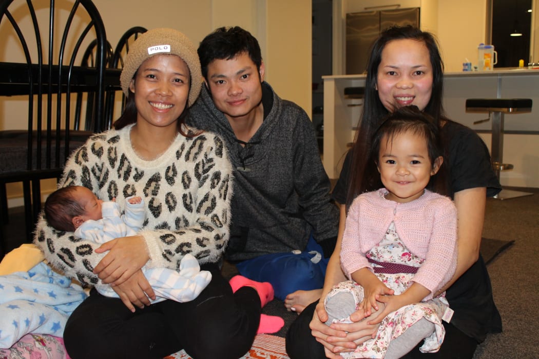 A photo of Vanny Yun with baby Sondra, her husband Sally Yen and Houng Yen holding Vanny and Sally's daughter, Sonila