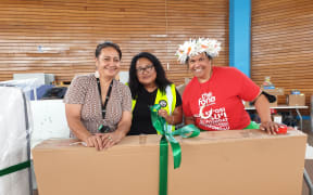 Staff members at The Fono are wrapping a bunk bed for families in need.