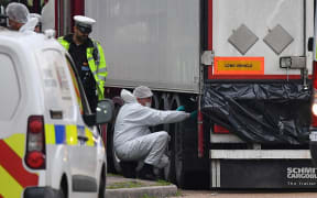 British Police forensics officers work on lorry, found to be containing 39 dead bodies, at Waterglade Industrial Park in Grays, east of London.