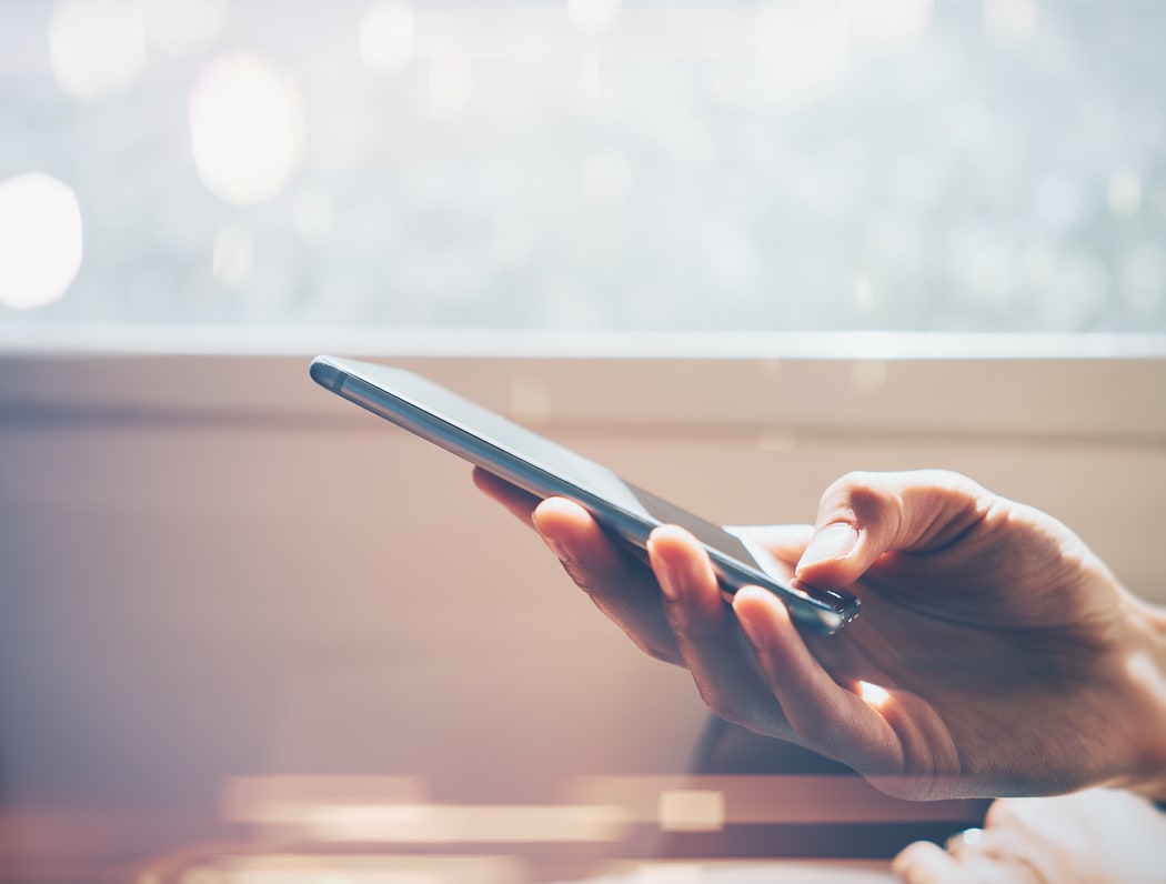 Close up of man's hand using smartphone with effects