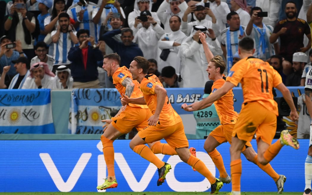 Wout Weghorst (L) of Netherlands reacts after scoring to tie the score in the second half during the FIFA World Cup quarter-final match Netherlands vs Argentina at Lusail Stadium in Al Daayen, Qatar on December 9, 2022.