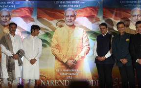 Actors and directors pose with posters of the upcoming Bollywood film  "PM Narendra Modi" - a biopic on Indian Prime Minister Narendra Modi. Actor Vivek Oberoi (2R) portrays the Indian Prime Minister in the film.