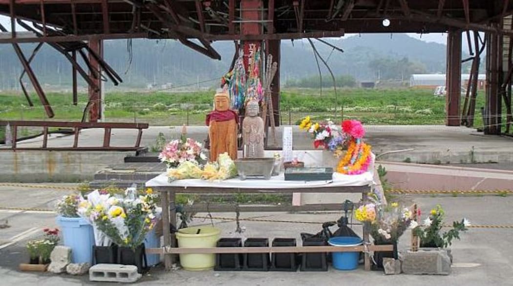 A shrine has been set up at the disaster prevention tower for people to pay their respects. However the council plans to demolish the building.