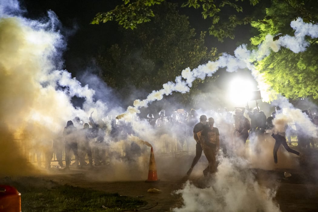 Tear gas rises as protesters face off with police during a demonstration outside the White House on 31 May over the death of George Floyd at the hands of Minneapolis Police.