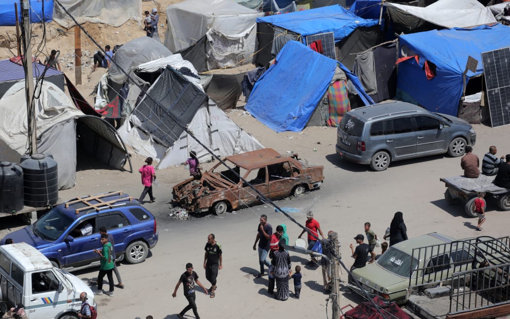 CORRECTION / Tents are set up along a street in Deir el-Balah in the central Gaza Strip by Palestinians who fled Rafah in the southern part of the Palestinian territory on May 12, 2024, amid the ongoing conflict between Israel and the Hamas militant group. (Photo by AFP) / “The erroneous mention[s] appearing in the metadata of this photo by Said KHATIB has been modified in AFP systems in the following manner: [stringer] instead of [Said Khatib]. Please immediately remove the erroneous mention[s] from all your online services and delete it (them) from your servers. If you have been authorized by AFP to distribute it (them) to third parties, please ensure that the same actions are carried out by them. Failure to promptly comply with these instructions will entail liability on your part for any continued or post notification usage. Therefore we thank you very much for all your attention and prompt action. We are sorry for the inconvenience this notification may cause and remain at your disposal for any...