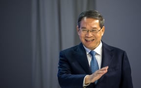 Chinese Premier Li Qiang arrives on stage during the annual meeting of the World Economic Forum (WEF) in Davos on January 16, 2024. (Photo by Fabrice COFFRINI / AFP)