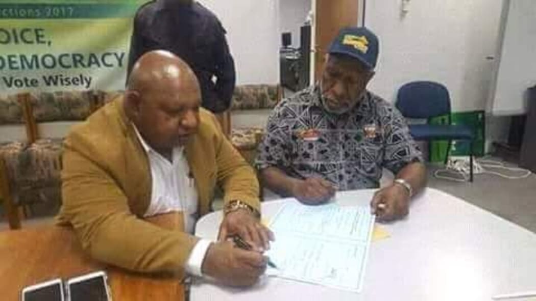 William Powi signs the election writ after winning back the Southern Highlands regional seat in Papua new Guinea.