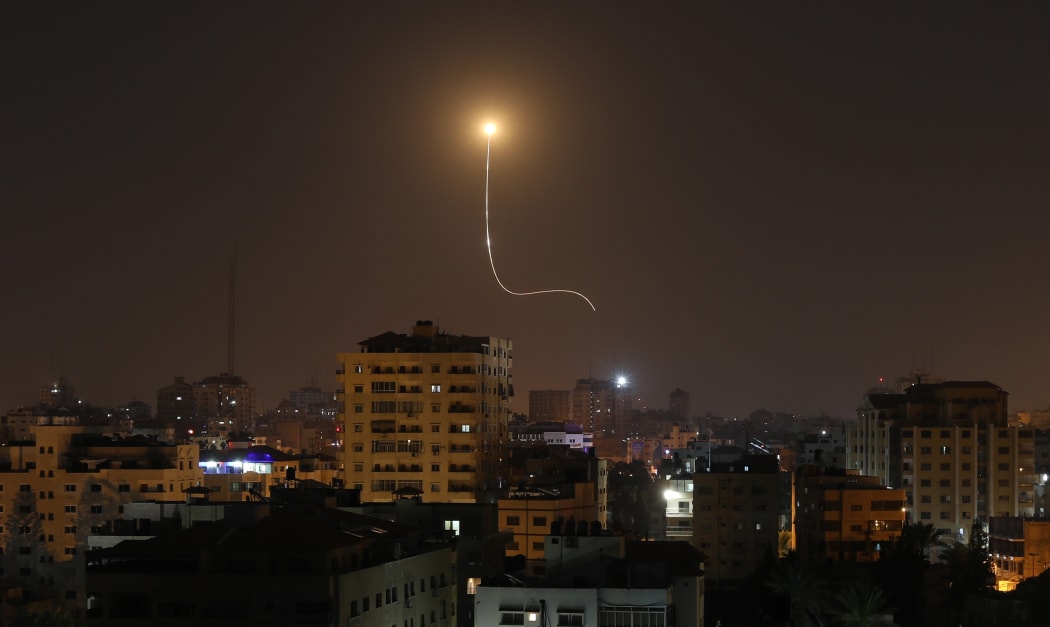 Israeli missile launched from the Iron Dome defence missile system, designed to intercept and destroy incoming short-range rockets and artillery shells, is seen above Gaza city on November 13, 2019. (Photo by MAHMUD HAMS / AFP)