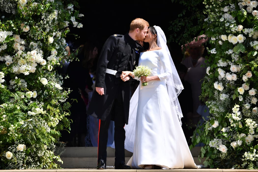 -- AFP PICTURES OF THE YEAR 2018 --

Britain's Prince Harry, Duke of Sussex kisses his wife Meghan, Duchess of Sussex as they leave from the West Door of St George's Chapel, Windsor Castle, in Windsor, on May 19, 2018 after their wedding ceremony. (Photo by Ben STANSALL / POOL / AFP)