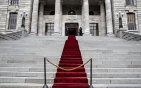 A red carpet runs up Parliament's front steps