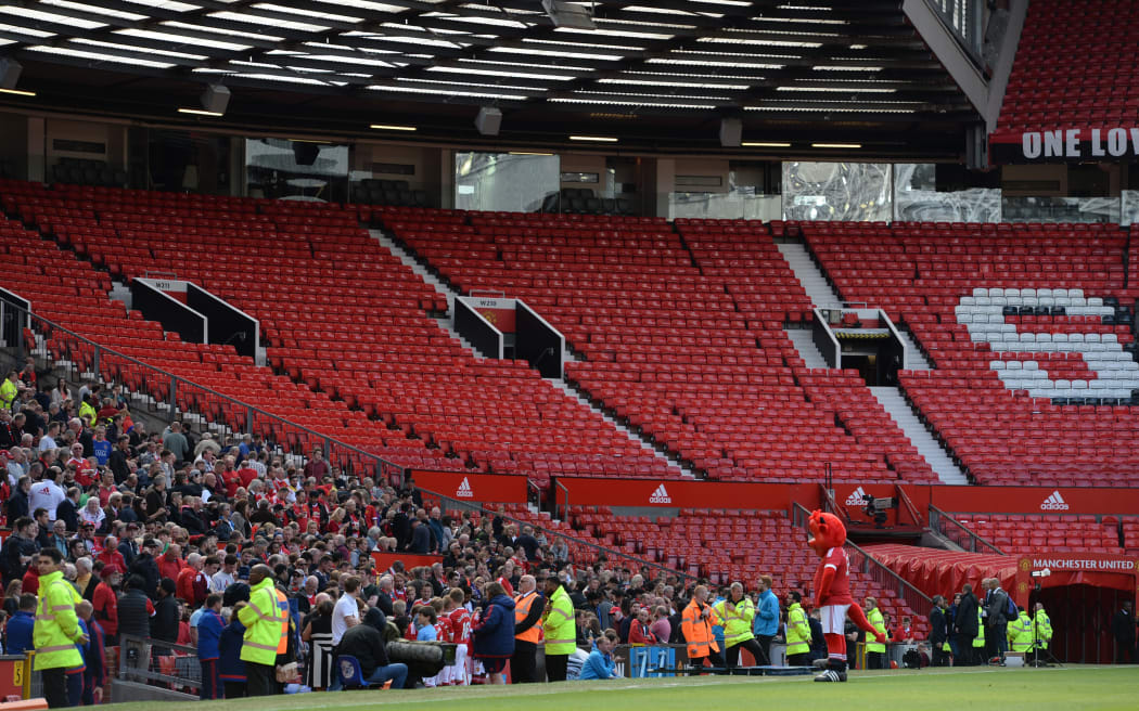 The Stretford End is pictured empty following the evacuation of both the Sir Alex Ferguson stand (unseen) and the Stretford stands ahead of the English Premier League football match between Manchester United and Bournemouth at Old Trafford in Manchester, north west England, on May 15, 2016.