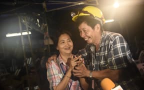 Family members of one of the missing boys celebrate while camping out near Than Luang cave following news all members of children's football team and their coach were alive in the cave at Khun Nam Nang Non Forest Park in the Mae Sai district of Chiang Rai province late July 2, 2018.