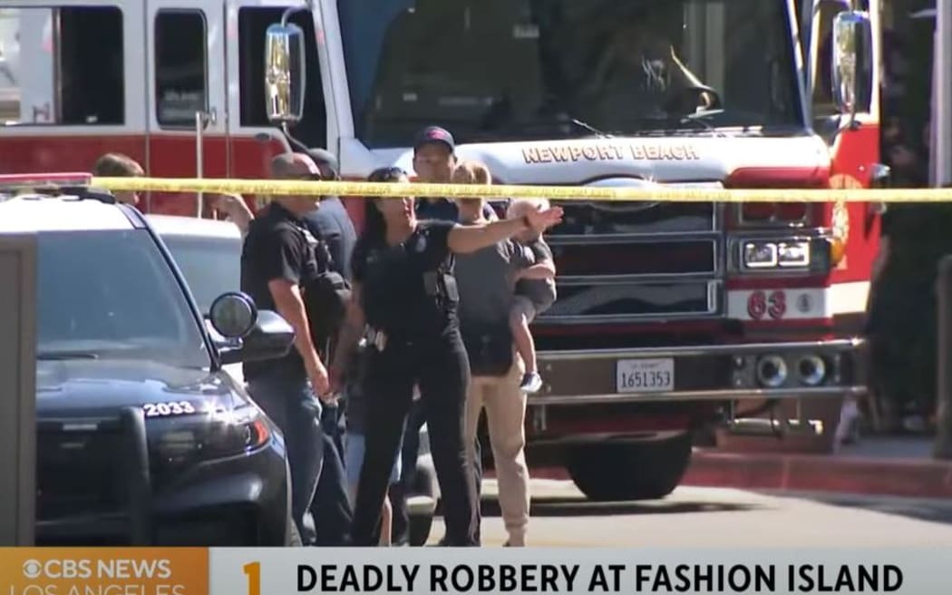 This screen grab from KCAL News/CBS television shows police outside the Newport Beach mall where a New Zealand woman died.