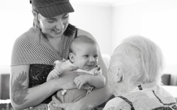 A baby meets an elderly man at a Wairarapa Intergenerational Playgroup.