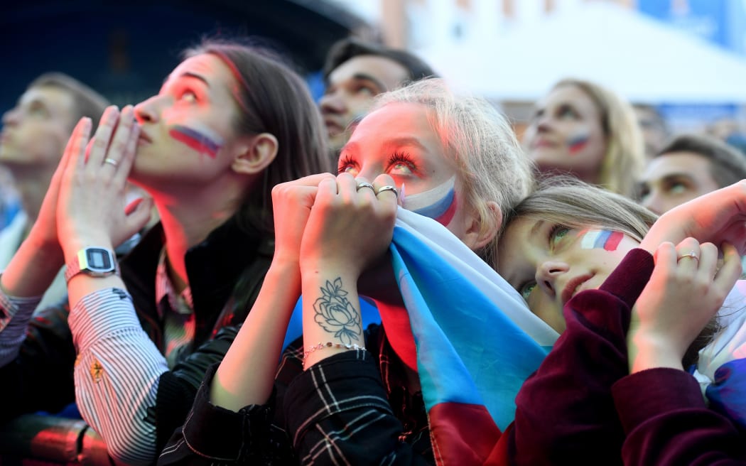 Russian fans watch the quarter-final football match between Russia and Croatia on a giant screen in Saint Petersburg on July 7, 2018 during the Russia 2018 football World Cup.