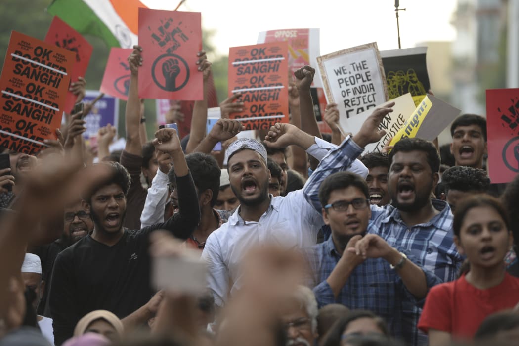 Students and demonstrators hold placards and shout slogans during a protest against India's new citizenship law in Chennai.
