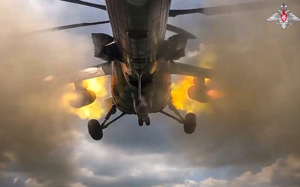An image taken from a handout footage released by the Russian Defence Ministry on August 21, 2024, reportedly shows a Russian Mi-35m attack helicopter firing rockets on Ukrainian Armed Forces at the border area of Kursk region in Russia. (Photo by Handout / Russian Defence Ministry / AFP) / RESTRICTED TO EDITORIAL USE - MANDATORY CREDIT "AFP PHOTO / RUSSIAN DEFENCE MINISTRY"  - NO MARKETING NO ADVERTISING CAMPAIGNS - DISTRIBUTED AS A SERVICE TO CLIENTS