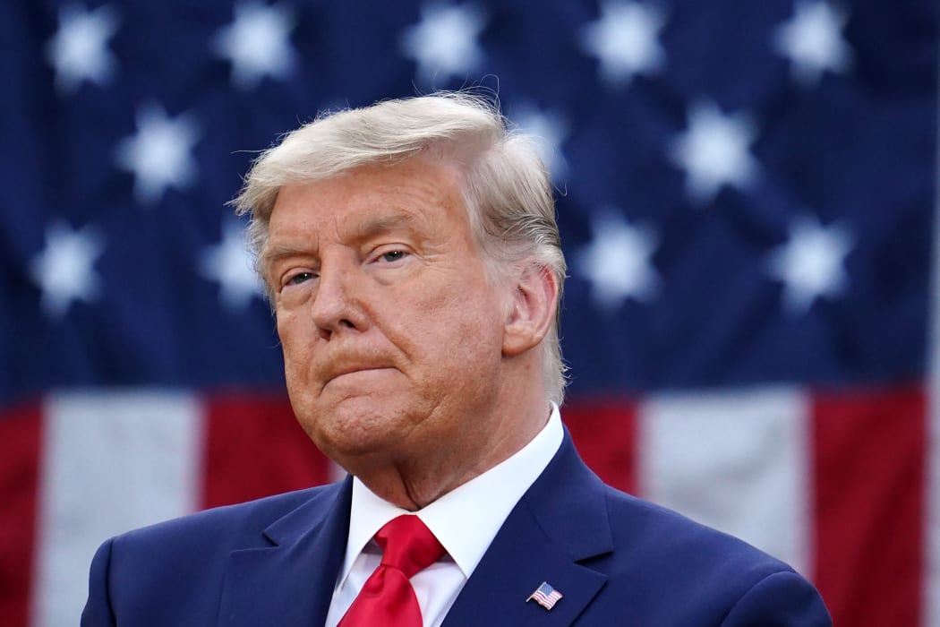 US President Donald Trump looks on after delivering an update on "Operation Warp Speed" in the Rose Garden of the White House in Washington, DC on November 13, 2020.