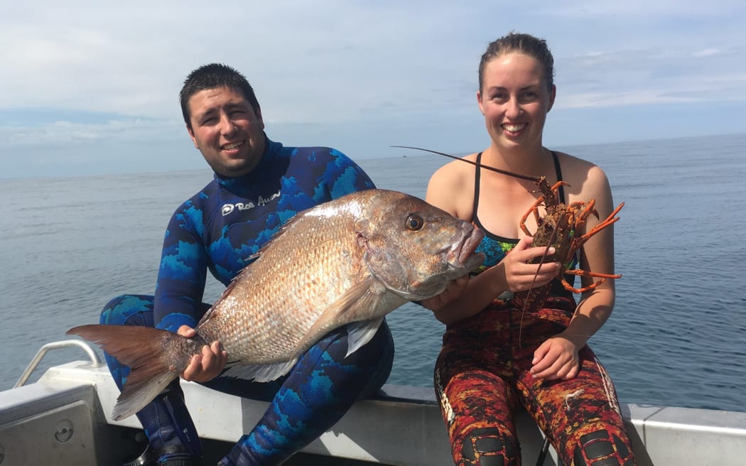 Jamie Newell and partner Melissa Churchouse. Newell says dredging tailings will wipe out a swathe of the area's reef fisheries.