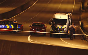 Police officers at the scene of the shootout last night.