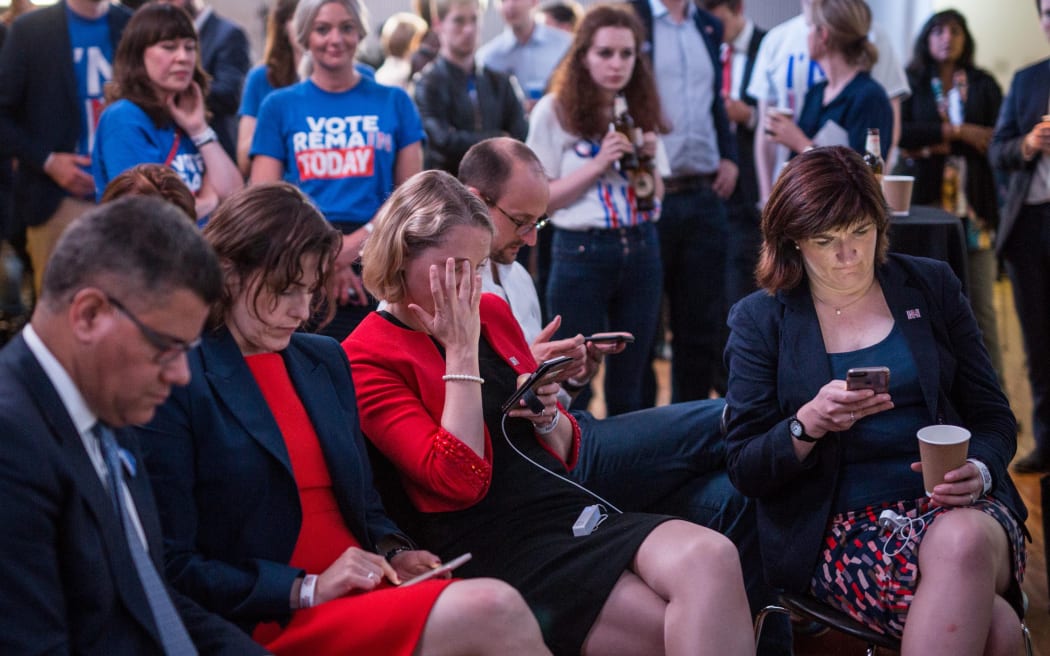 Supporters of the 'Stronger In' Campaign react as results of the EU referendum are announced at a results party at the Royal Festival Hall in London early in the morning of June 24, 2016.